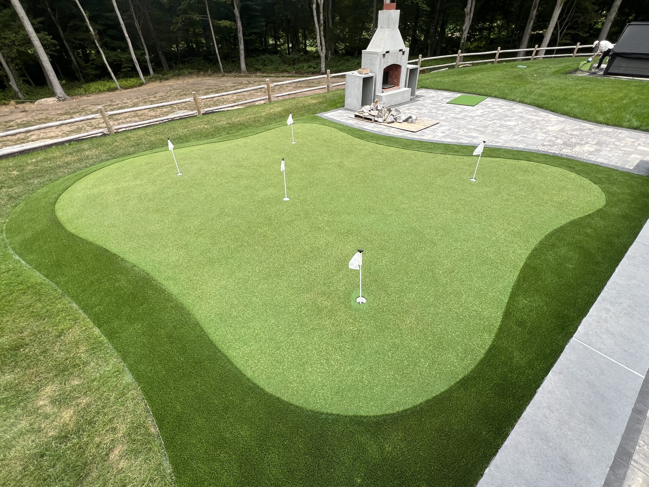 IMG_6462 Golf ball with putter and corner hole on green artificial turf